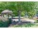 Community playground area with a gazebo, splash pad, picnic tables, and play equipment at 5730 Paces Pl, Suwanee, GA 30024