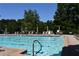 Large swimming pool with lounge chairs and manicured deck provides a relaxing and enjoyable outdoor amenity for residents at 5730 Paces Pl, Suwanee, GA 30024