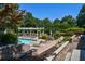 Beautiful swimming pool with elegant pergola, ample lounge chairs, and manicured greenery creates an inviting outdoor retreat at 5730 Paces Pl, Suwanee, GA 30024