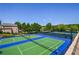 Community tennis courts featuring green and blue surfaces offer an active lifestyle in a beautiful outdoor setting at 5730 Paces Pl, Suwanee, GA 30024