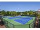 Multiple tennis courts surrounded by lush trees provide a recreational amenity for residents to enjoy outdoor activities at 5730 Paces Pl, Suwanee, GA 30024