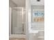 Bathroom featuring a glass-enclosed shower, soaking tub, and a window with natural light at 619 Rivulett Ct, Lawrenceville, GA 30043