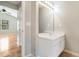 Bathroom vanity featuring a white cabinet, sink, mirror and lighting at 619 Rivulett Ct, Lawrenceville, GA 30043