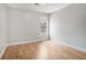 Bedroom features hardwood floors, a window with natural light, and neutral-colored walls at 619 Rivulett Ct, Lawrenceville, GA 30043