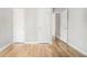 Bedroom featuring hardwood floors and multiple white doors leading to closets and other rooms at 619 Rivulett Ct, Lawrenceville, GA 30043