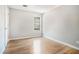 Bright bedroom with hardwood floors, neutral walls, and a window offering natural light at 619 Rivulett Ct, Lawrenceville, GA 30043