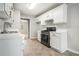 Modern kitchen with stainless steel appliances, white cabinets, and functional layout at 619 Rivulett Ct, Lawrenceville, GA 30043