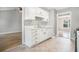 Well-lit kitchen featuring white cabinets, modern hardware, and a stainless-steel sink at 619 Rivulett Ct, Lawrenceville, GA 30043