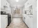 Well-lit kitchen with white cabinets, modern appliances, and a dining area at 619 Rivulett Ct, Lawrenceville, GA 30043