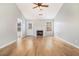 Bright living room with hardwood floors, fireplace, and natural light from windows and a glass door at 619 Rivulett Ct, Lawrenceville, GA 30043