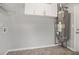 Utility room featuring a modern water heater, overhead storage, and tile floors at 619 Rivulett Ct, Lawrenceville, GA 30043