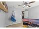 Bright bedroom with ceiling fan, bookshelf, comfortable hammock chair and a large monitor at 8740 Jenkins Rd, Winston, GA 30187