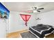 Bright bedroom featuring a ceiling fan, red curtains and a flat screen TV at 8740 Jenkins Rd, Winston, GA 30187