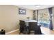 Dining area features a table, neutral paint, light wood flooring, and a sliding glass door that goes to a deck at 8740 Jenkins Rd, Winston, GA 30187