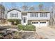 Split-level home featuring neutral siding, black shutters, and a well-maintained front yard with mature landscaping at 8740 Jenkins Rd, Winston, GA 30187