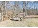 Wood pergola with bench swing and firepit situated in backyard at 8740 Jenkins Rd, Winston, GA 30187