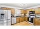 The kitchen features stainless steel appliances, updated cabinets, and stylish countertops for a modern feel at 8740 Jenkins Rd, Winston, GA 30187