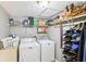 Cozy laundry room equipped with a washer, dryer, and shelving for storage at 8740 Jenkins Rd, Winston, GA 30187