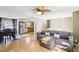 Hardwood floors lead from the dining area and living room, complete with a modern ceiling fan and comfortable sofa at 8740 Jenkins Rd, Winston, GA 30187
