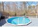 Inviting backyard pool on a spacious deck with seating and serene nature views at 8740 Jenkins Rd, Winston, GA 30187