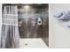 Tile shower featuring dual shower heads and a blue glass accent at 8740 Jenkins Rd, Winston, GA 30187