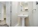 Powder room featuring pedestal sink, neutral color palette and a bright inset mirror reflecting the space at 195 14Th Ne St # Ts8, Atlanta, GA 30309