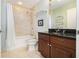 Bathroom featuring a shower and tub with beautiful marble tile work, as well as a cherry wood vanity at 195 14Th Ne St # Ts8, Atlanta, GA 30309
