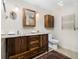 Bathroom with double sink vanity, wood cabinets, soft lighting, and radiant heat towel bar at 195 14Th Ne St # Ts8, Atlanta, GA 30309