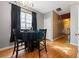 A simply styled dining room with wood floors is set for four in this well lit home at 2322 Coach Way, Jonesboro, GA 30236