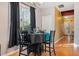 A simply styled dining room with wood floors is set for four in this well lit home at 2322 Coach Way, Jonesboro, GA 30236