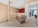 Hallway featuring carpeting, decorative chair, half wall and open doorway into bedroom at 2322 Coach Way, Jonesboro, GA 30236