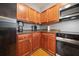 Kitchen featuring wood cabinets, dark countertops and stainless steel appliances at 2322 Coach Way, Jonesboro, GA 30236