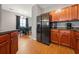 Kitchen with stainless steel appliances, eat in dining area, and hardwood flooring at 2322 Coach Way, Jonesboro, GA 30236