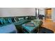 Open-concept living room boasts natural light, hardwood floors, an oversized sofa and connected dining area at 2322 Coach Way, Jonesboro, GA 30236