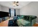 Living room featuring hardwood flooring and a large sofa with decorative pillows at 2322 Coach Way, Jonesboro, GA 30236