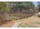 Scenic view of a serene pond surrounded by trees and a paved path, perfect for relaxation at 2322 Coach Way, Jonesboro, GA 30236