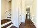 Inviting hallway with hardwood floors, white trim, and staircase leading to the upper level at 2795 Greenbridge Drive, Norcross, GA 30071