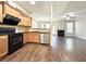 Open-concept kitchen with stainless steel appliances, tile backsplash, and hardwood flooring at 2795 Greenbridge Drive, Norcross, GA 30071
