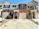 Charming brick townhouse with a one-car garage and a welcoming front entrance and driveway at 2795 Greenbridge Drive, Norcross, GA 30071