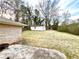 Spacious backyard featuring a storage shed, mature trees, and a patio area at 3081 Oak Dr, Lawrenceville, GA 30044