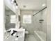 Updated bathroom featuring modern vanity, marble-look tiling, and a shower-tub combo at 3081 Oak Dr, Lawrenceville, GA 30044