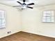 Bedroom featuring light wood flooring, white walls, two windows, and a ceiling fan at 3081 Oak Dr, Lawrenceville, GA 30044