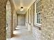 Long covered patio area features brick columns, a whitewashed ceiling, and outdoor lighting at 3081 Oak Dr, Lawrenceville, GA 30044
