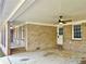 A spacious covered patio area featuring brick columns, ceiling fan, and a whitewashed ceiling at 3081 Oak Dr, Lawrenceville, GA 30044