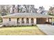 Charming home featuring a brick facade, arched entry, and convenient carport at 3081 Oak Dr, Lawrenceville, GA 30044