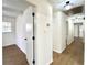 Hallway featuring light wood flooring, white walls, and updated light fixtures at 3081 Oak Dr, Lawrenceville, GA 30044