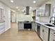 Open kitchen with stainless steel appliances, hardwood floors, and a modern design at 3081 Oak Dr, Lawrenceville, GA 30044