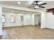 Open-concept living room with light wood flooring, white walls, and a ceiling fan at 3081 Oak Dr, Lawrenceville, GA 30044