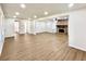 Bright living room showcasing light wood flooring and a brick fireplace with black trim at 3081 Oak Dr, Lawrenceville, GA 30044