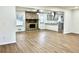 Open-concept living room featuring a brick fireplace, a ceiling fan, and hardwood floors at 3081 Oak Dr, Lawrenceville, GA 30044